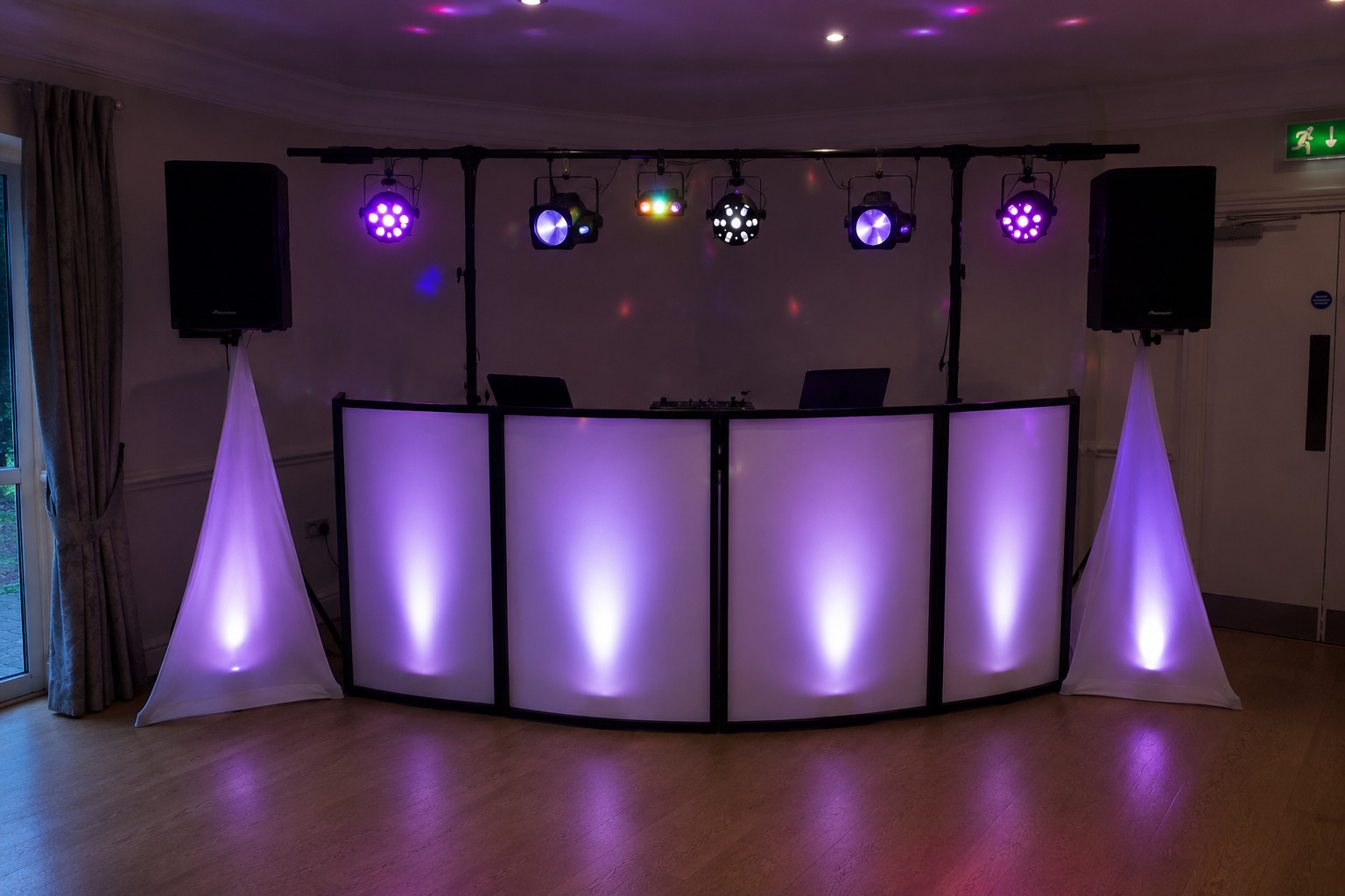 Professional mobile DJ setup with white facade, uplighting and stage lights