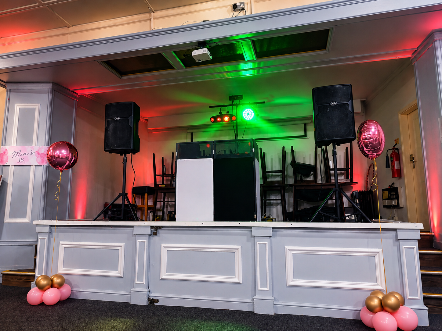 First Class Entertainment DJ setup with speakers and lighting at a live event